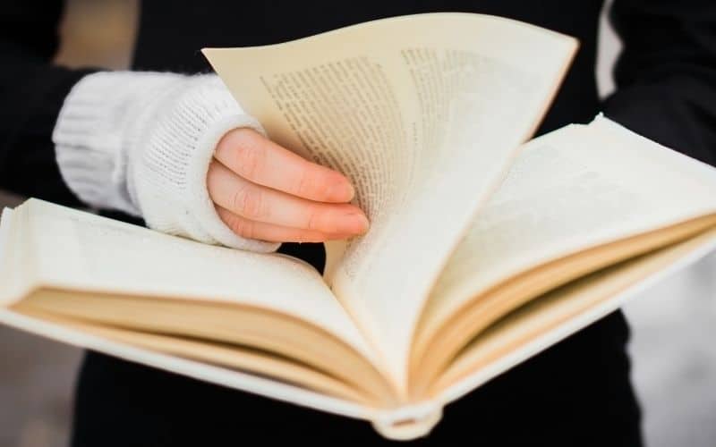 woman flipping a book