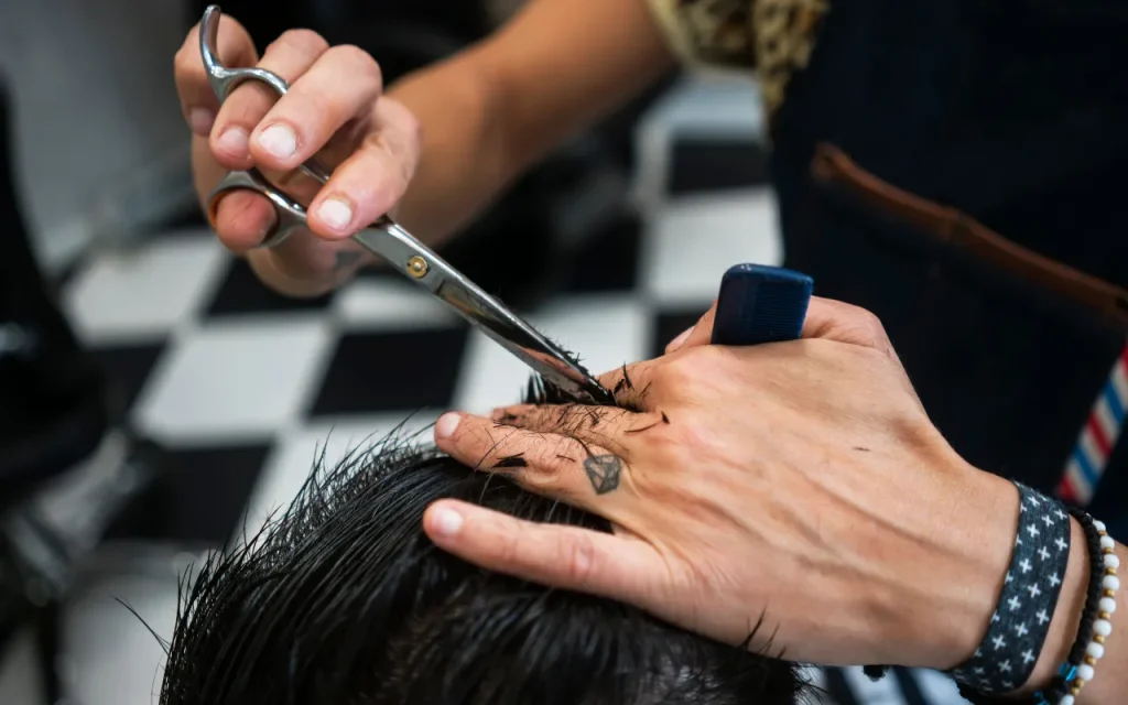 man cutting hair as barber