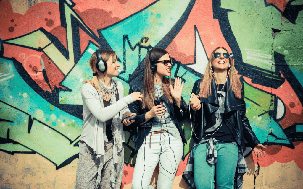 undergraduate students in front of graffiti art wall