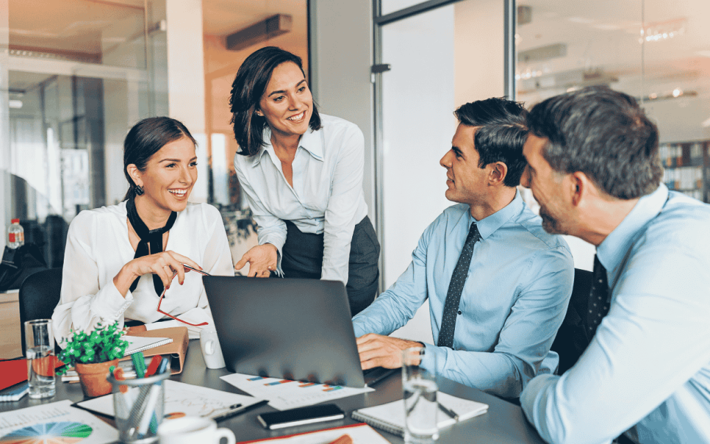 two female business executives in a discussion with two male businessmen