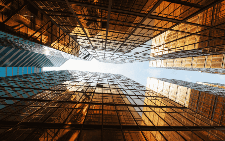 photo of the sky taken from between two skyscrapers looking up