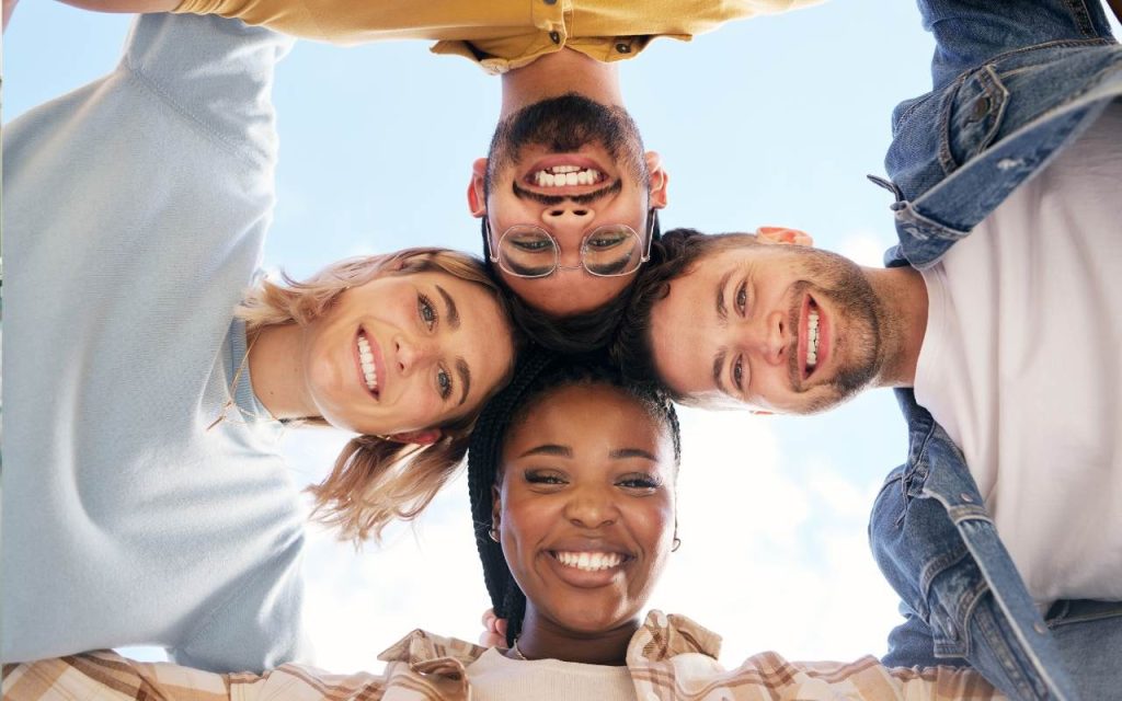 four students put their heads together