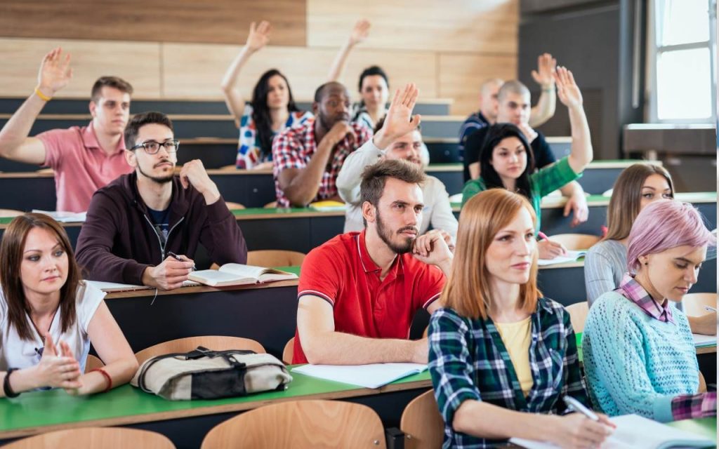 law students raise their hands in a classroom