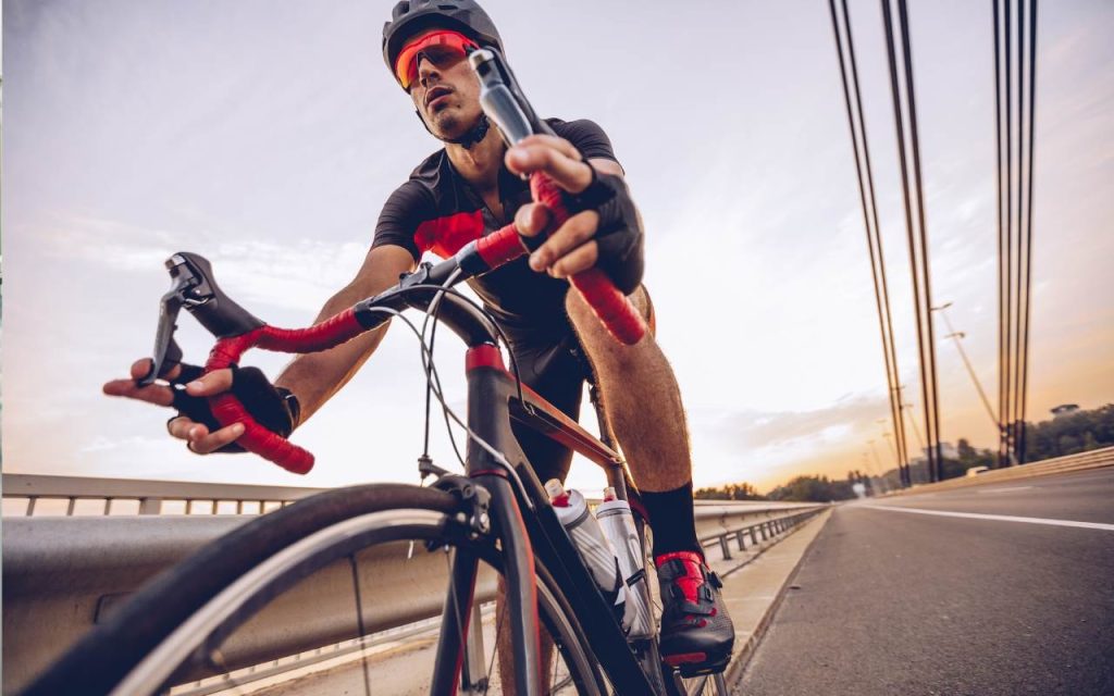 man on bike rides down highway