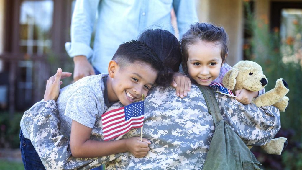 military parent hugs children