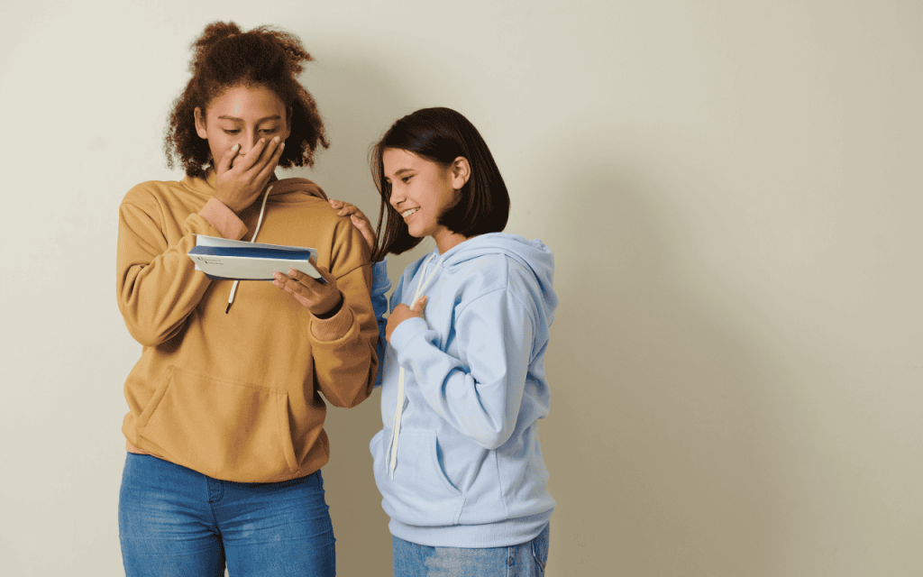 two students read a college acceptance letter