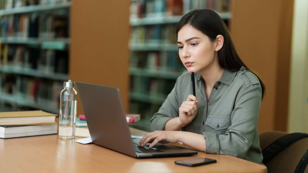 student studies in michigan university library