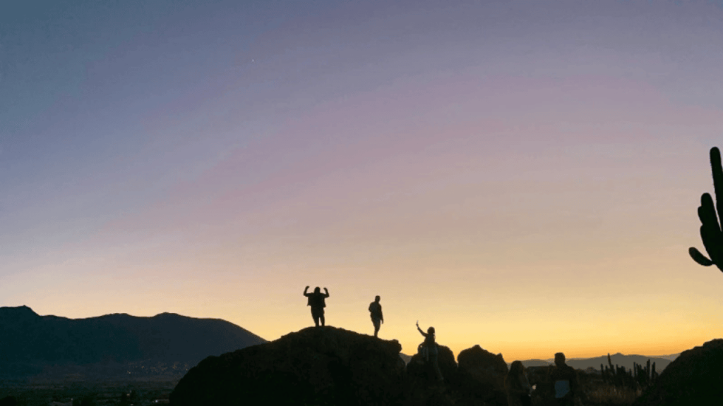 silhouettes of children climbing rocks