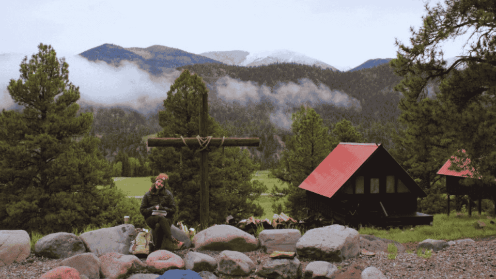 mother sitting at campsite with backpack