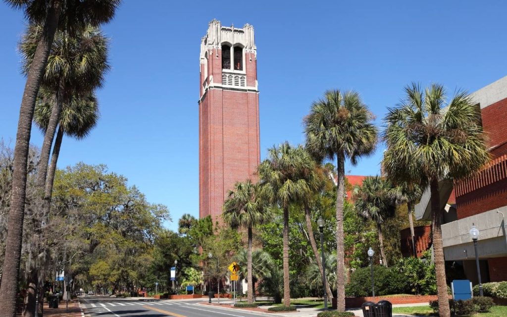 red brick tower stands among palm trees in Florida