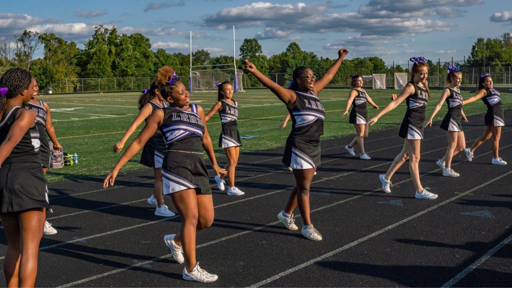 cheerleaders on track field in formation