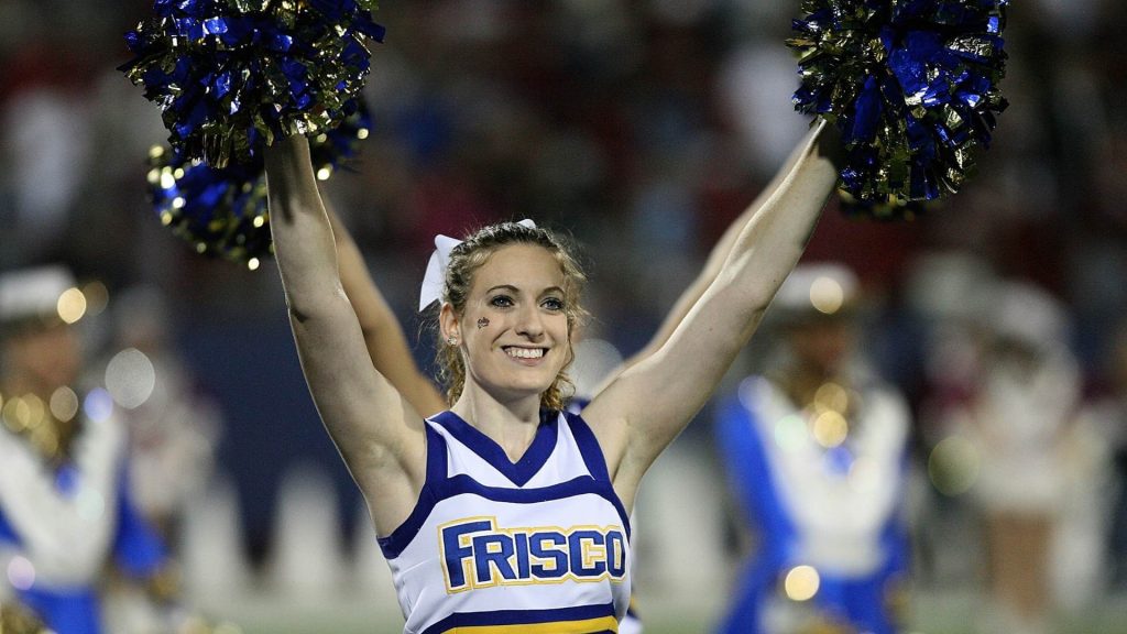 smiling cheerleader with pom-poms