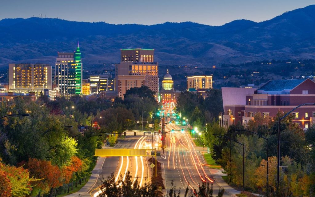 brightly lit street in Idaho with mountains in the background