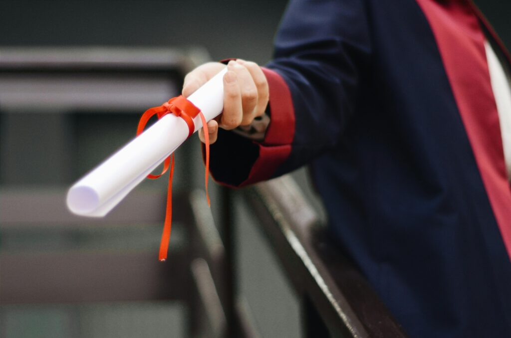 Graduate holding a diploma.