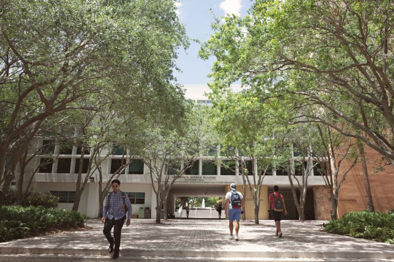 Students walking through a sunlit university campus in Coral Gables, Florida